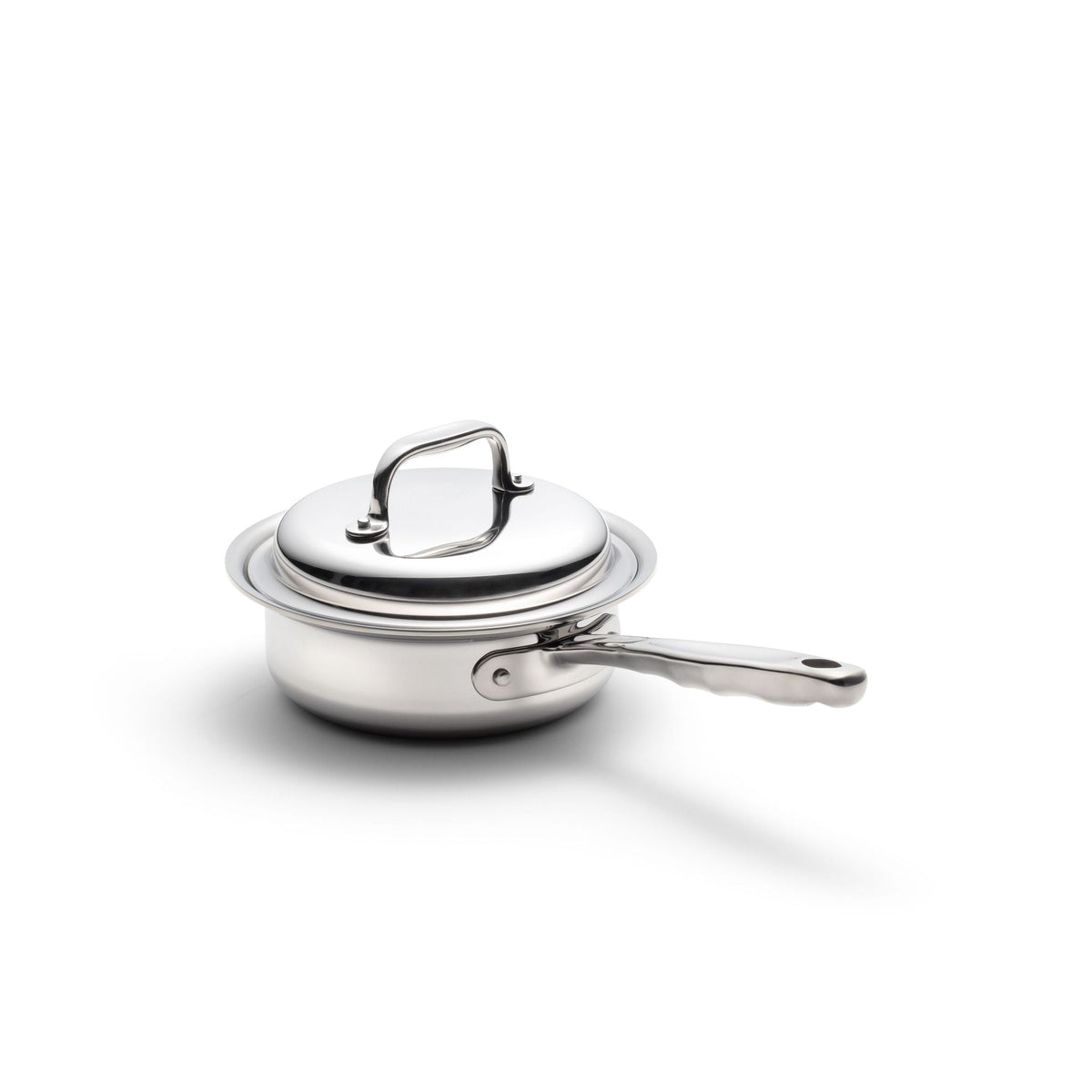 Stainless steel pot with lid on a white background