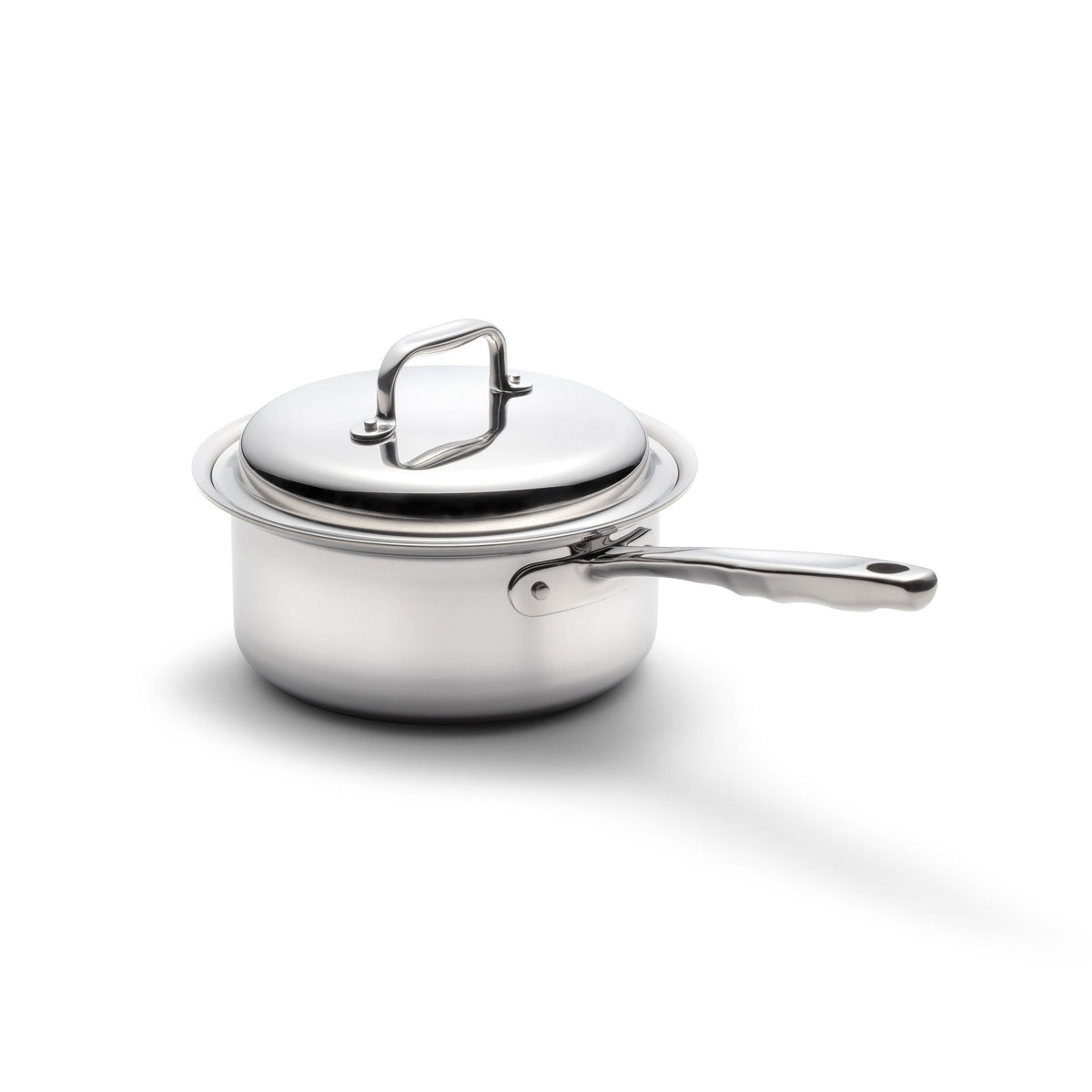 Stainless steel saucepan with lid on a white background