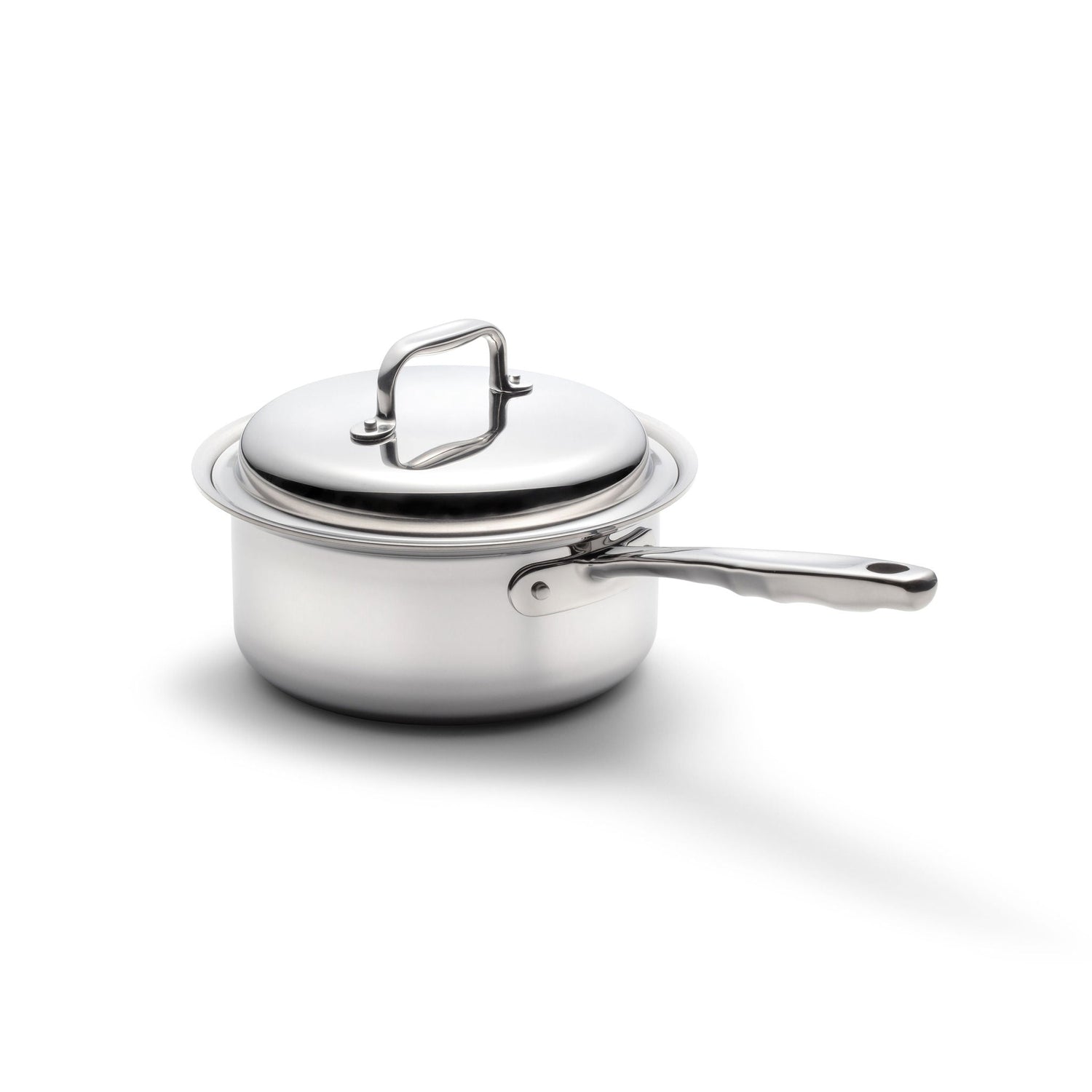 Stainless steel saucepan with lid on a white background