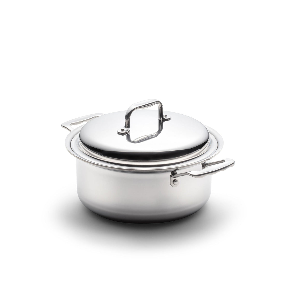 Stainless steel pot with lid on a white background