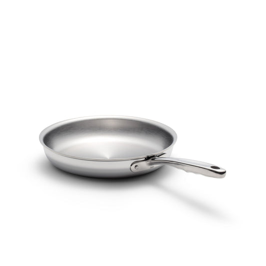 Stainless steel frying pan on a white background