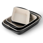 Set of three ceramic dishes with black rims on a white background