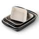 Set of three ceramic dishes with black rims on a white background