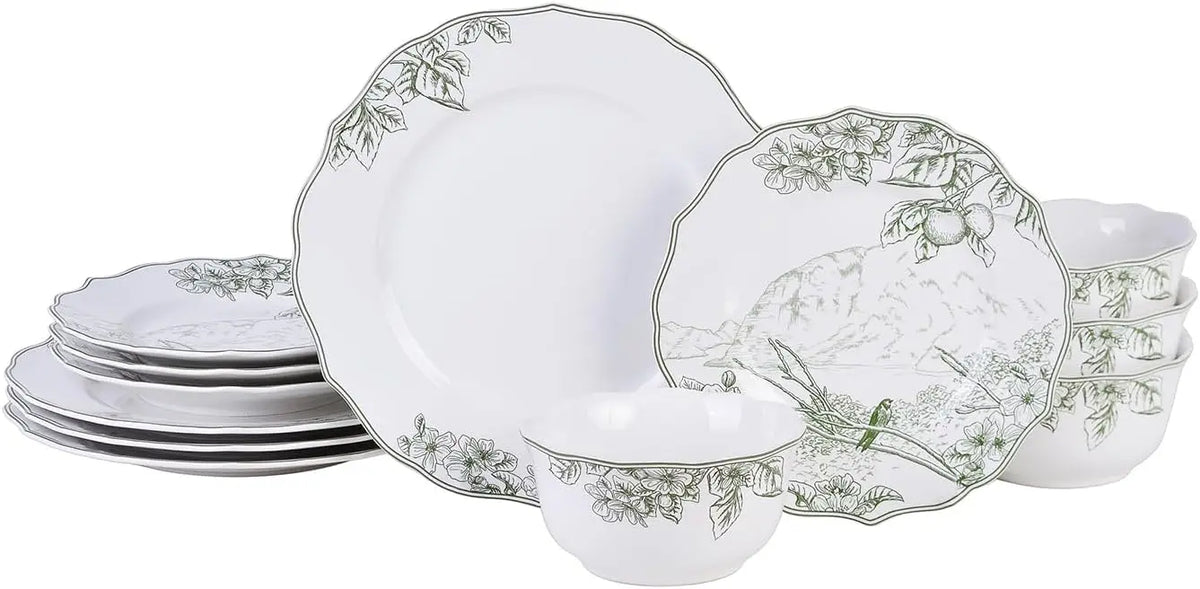 Set of white ceramic plates with decorative green patterns on a white background
