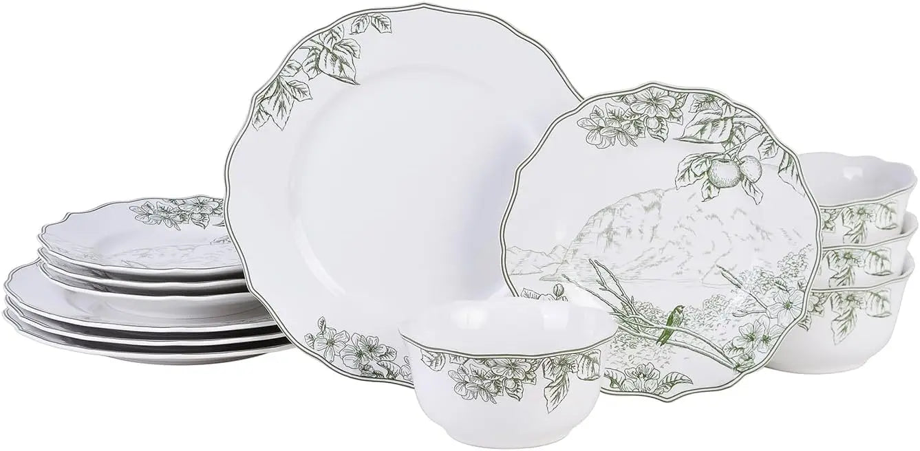 Set of white ceramic plates with decorative green patterns on a white background