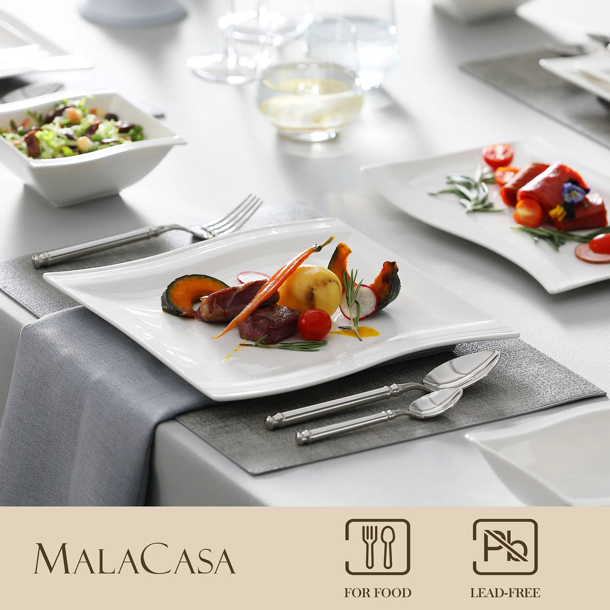 Dining table setting with plates of food and cutlery, featuring the Malacasa brand.