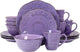 Purple ceramic dinnerware set with cups and bowls on a white background
