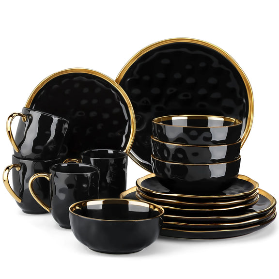 Black ceramic dinnerware set with gold accents on a white background
