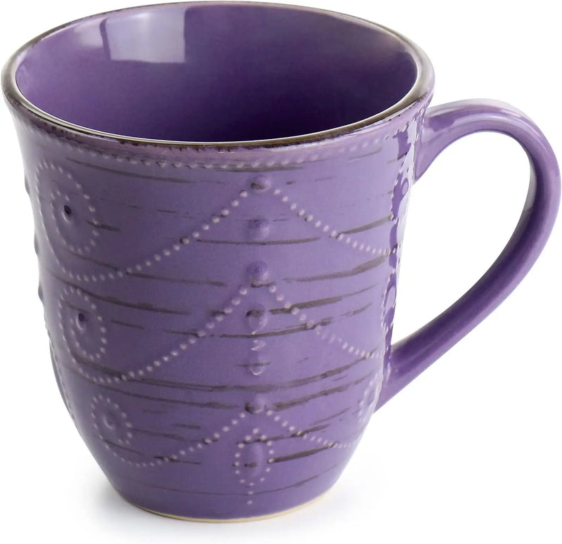 Purple ceramic mug with decorative patterns on a white background