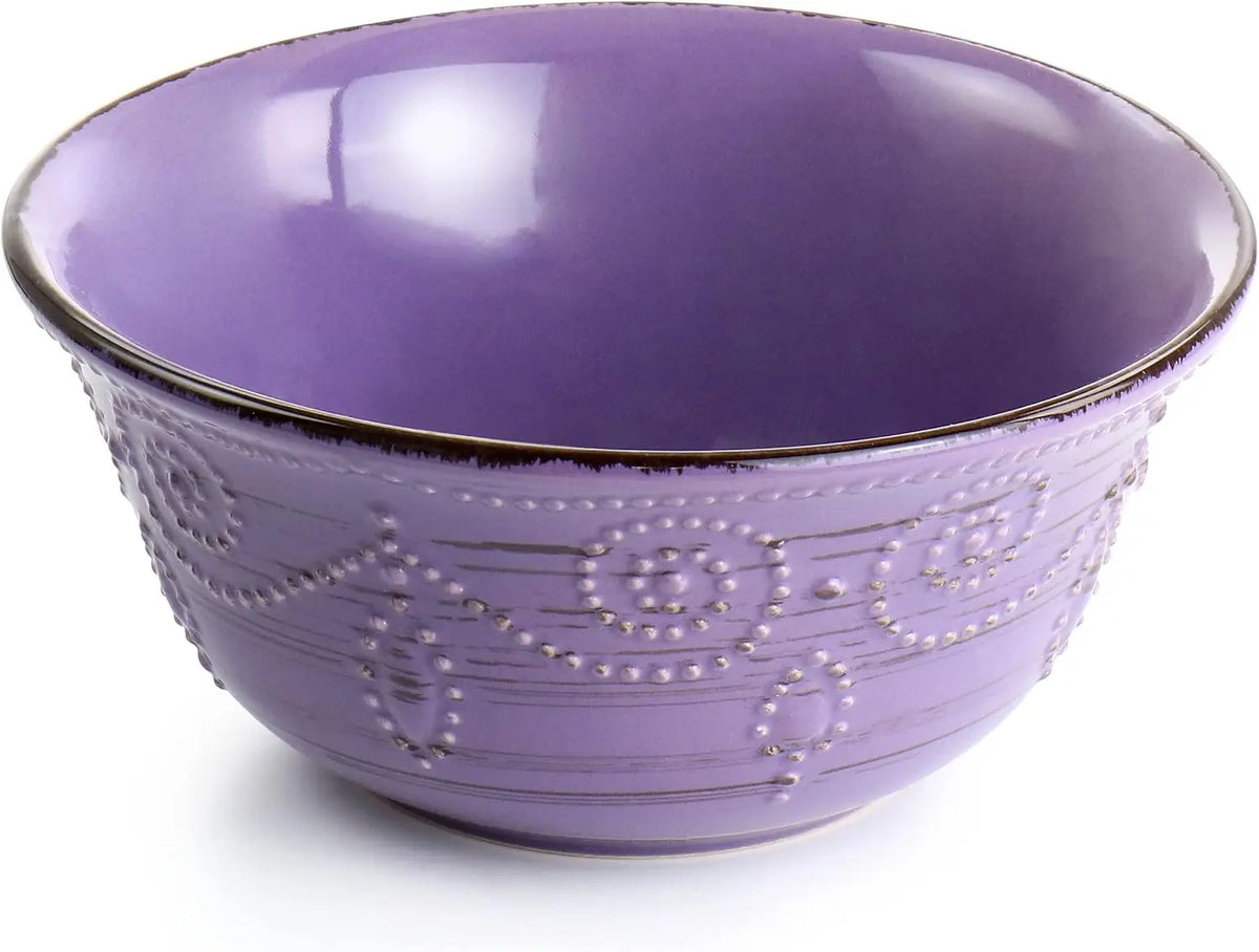 Purple ceramic bowl with decorative patterns on a white background