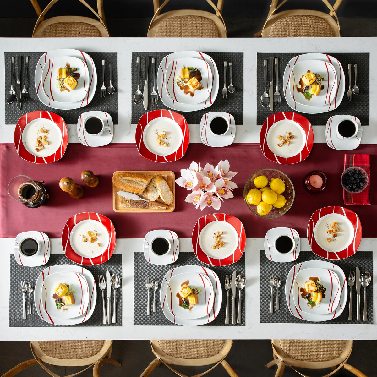 Dining table set with plates, cups, and food arranged on a checkered tablecloth.