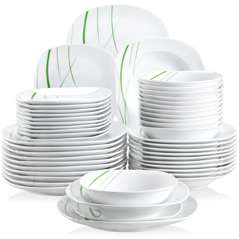 Set of white dinnerware with green accents on a white background