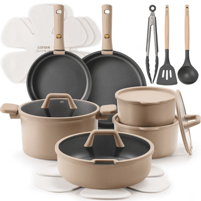 Set of cookware including pots, pans, and utensils on a white background