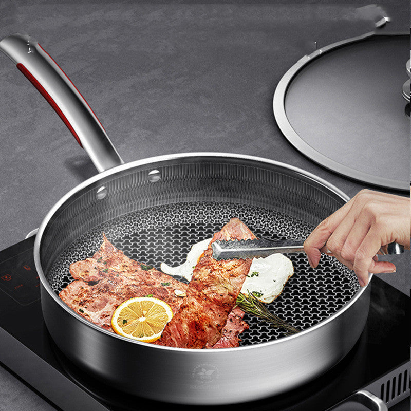Stainless steel frying pan with food on a stovetop
