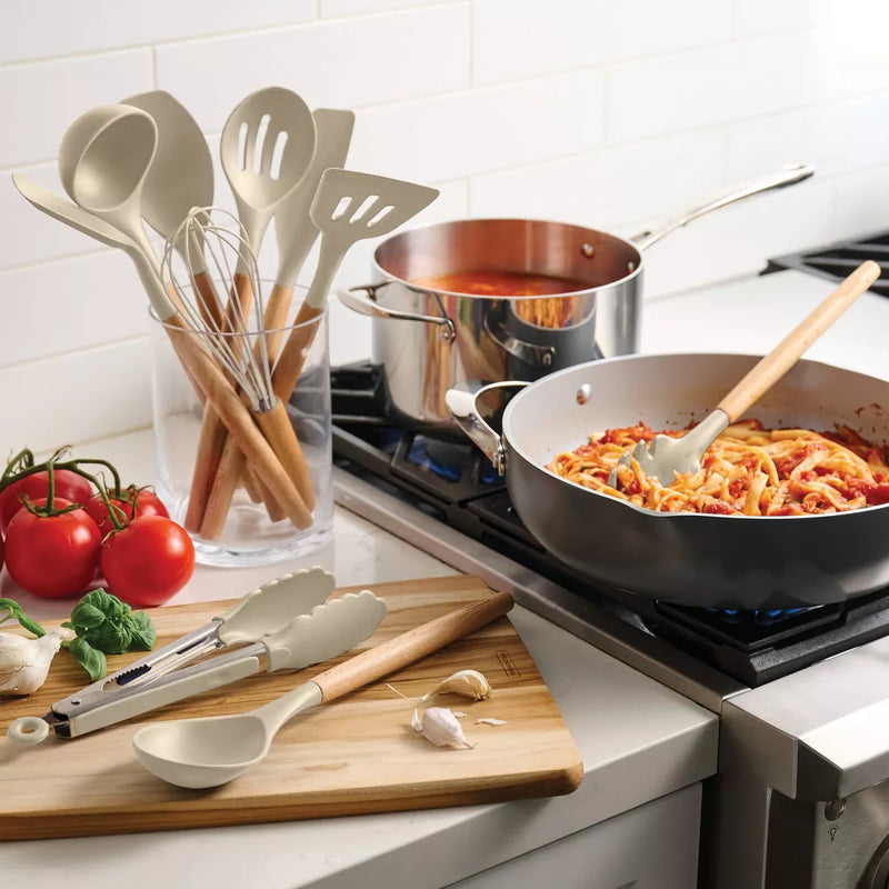 Kitchen scene with cooking utensils, pots, and a stove with food.