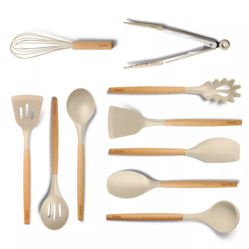 Set of kitchen utensils including a whisk, tongs, spatulas, and spoons on a white background