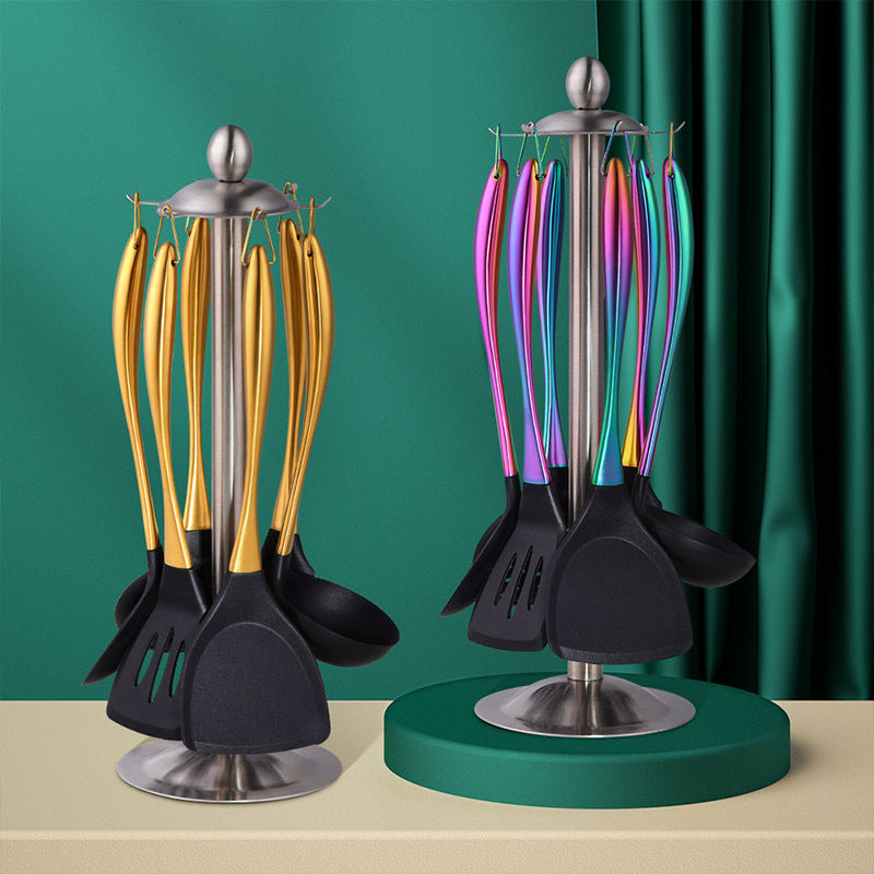 Set of kitchen utensils on stands with gold, black, and colorful spoons against a green curtain.