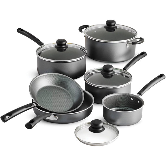 Set of black cookware with glass lids on a white background