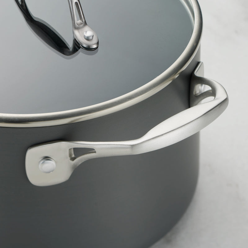 Gray pot with a lid on a light gray background