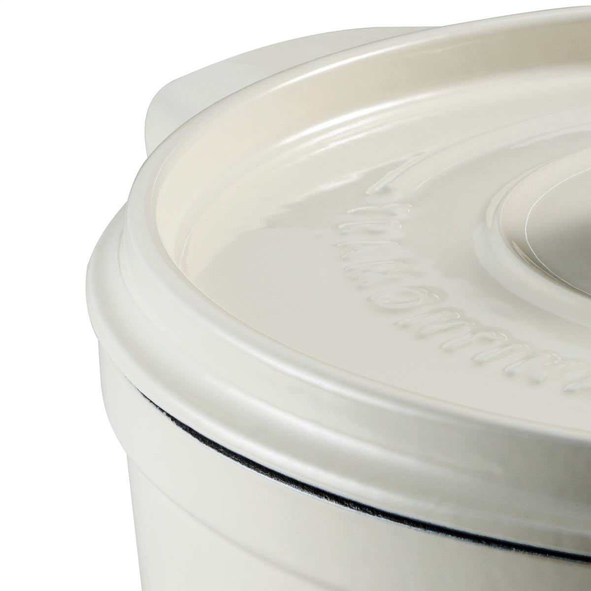 Close-up of a white dutch oven with a lid on a white background