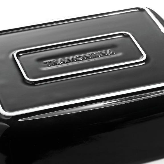 Close-up of a black container with a silver logo on a white background