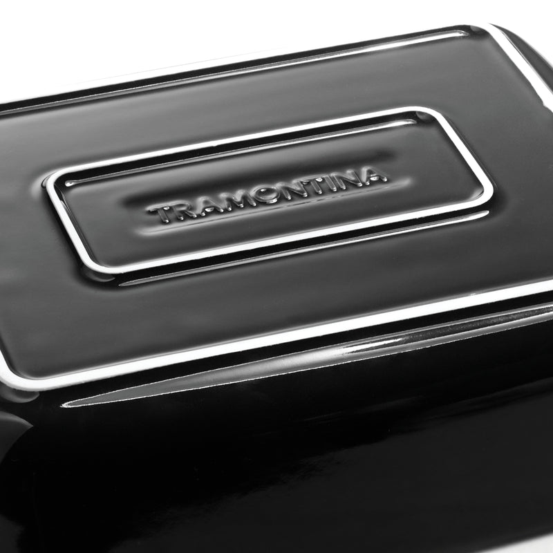 Close-up of a black container with a silver logo on a white background