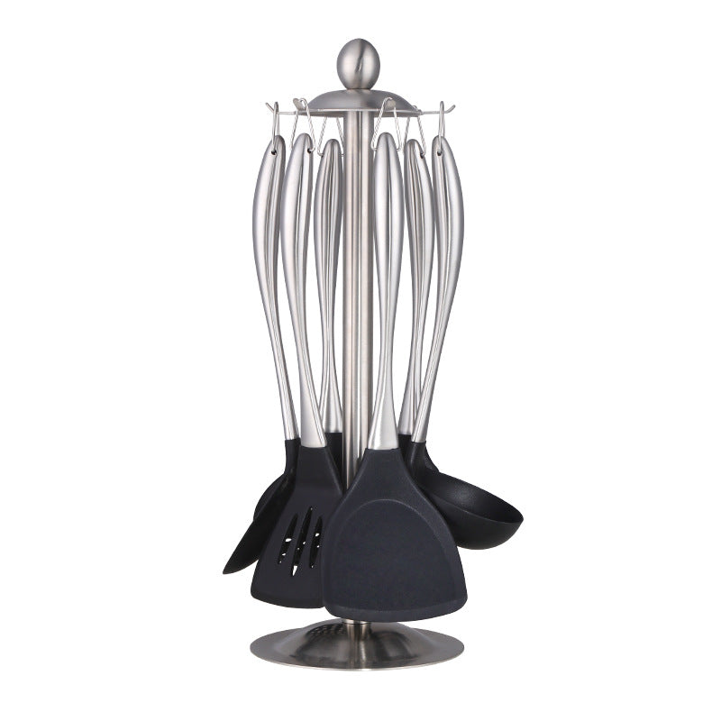 Set of black kitchen utensils with silver stands on a white background