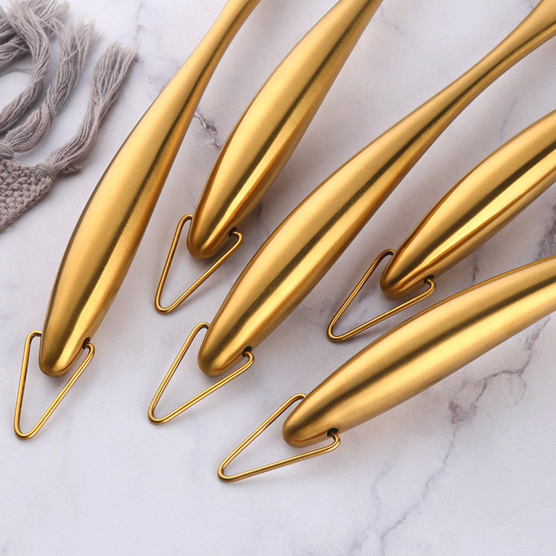 Gold-colored hooks on a marble surface