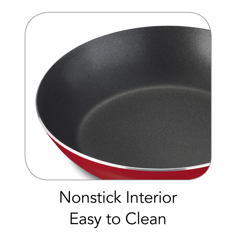 Black frying pan with red interior rim on a white background