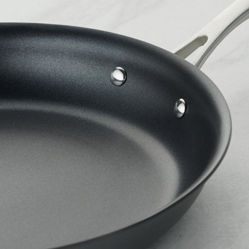 Black frying pan on a light gray background