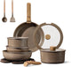 Set of cookware including pots, pans, and lids on a white background