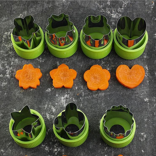 Set of green cookie cutters with various shapes on a dark surface.