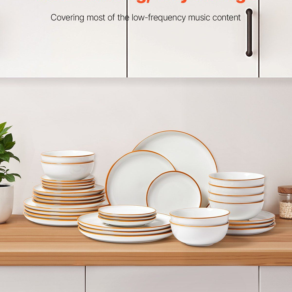 White dinnerware set with gold rims on a wooden shelf against a white cabinet background.