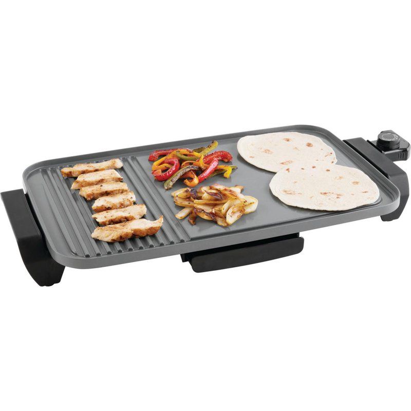 Electric grill with food items on a white background
