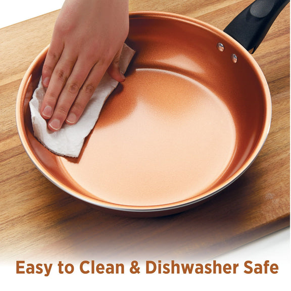 Person cleaning a copper-colored frying pan with a cloth on a wooden surface, with text 'Easy to Clean & Dishwasher Safe'.