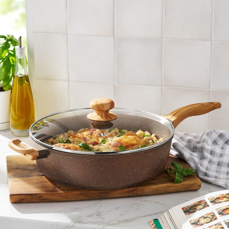 Cooking pan with lid on a wooden cutting board in a kitchen setting