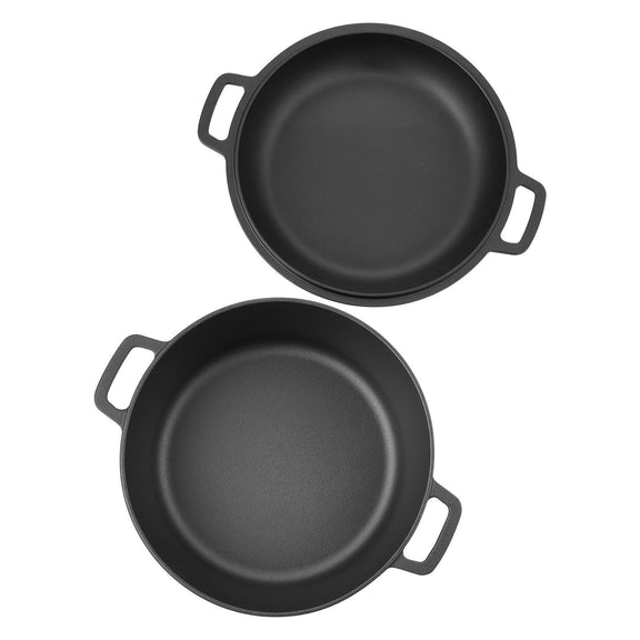 Two black cast iron skillets on a white background