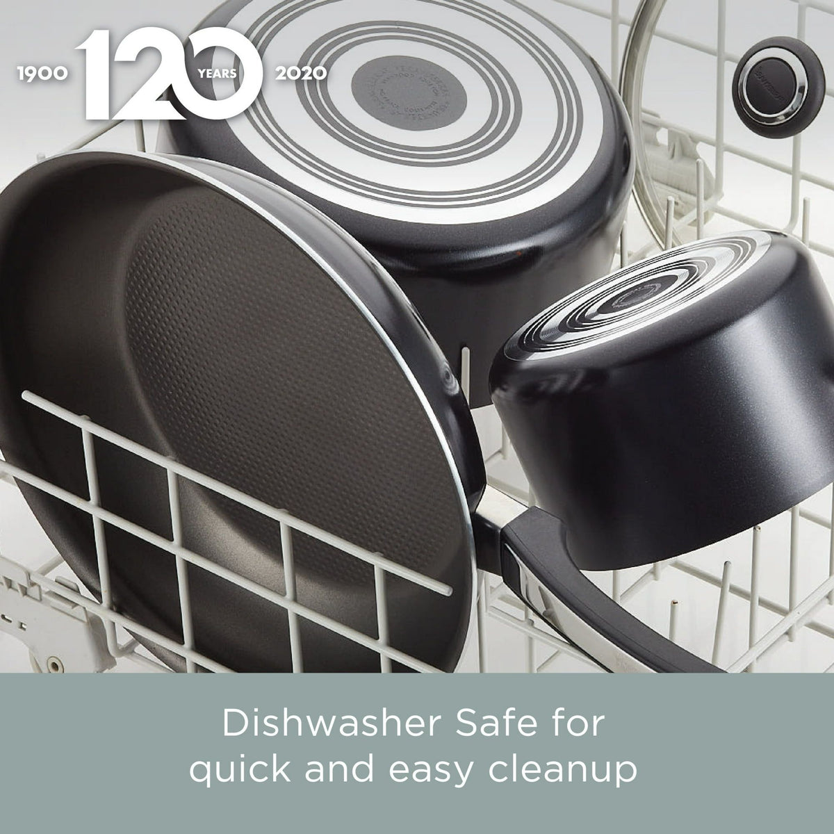 Black cookware set in a dishwasher with a 120th anniversary logo.