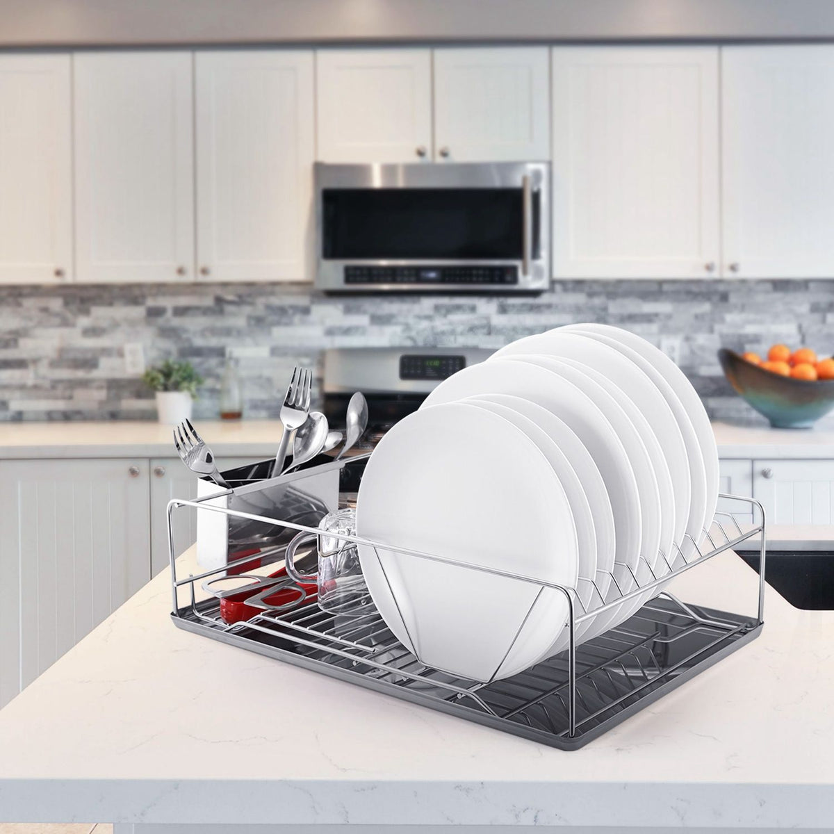Dish rack with plates and utensils on a kitchen counter