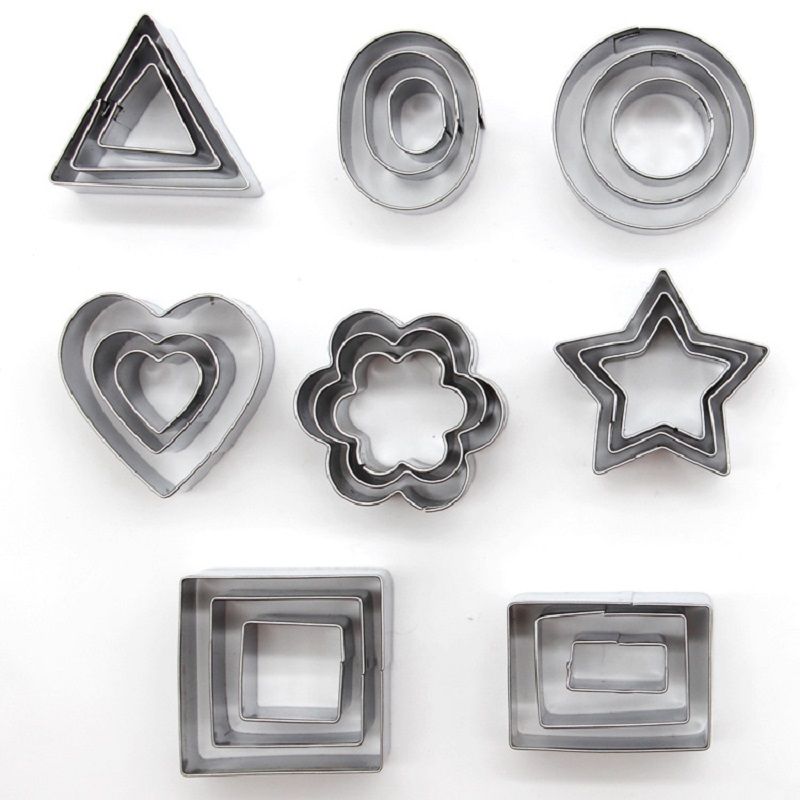 Set of metal cookie cutters in various shapes on a white background