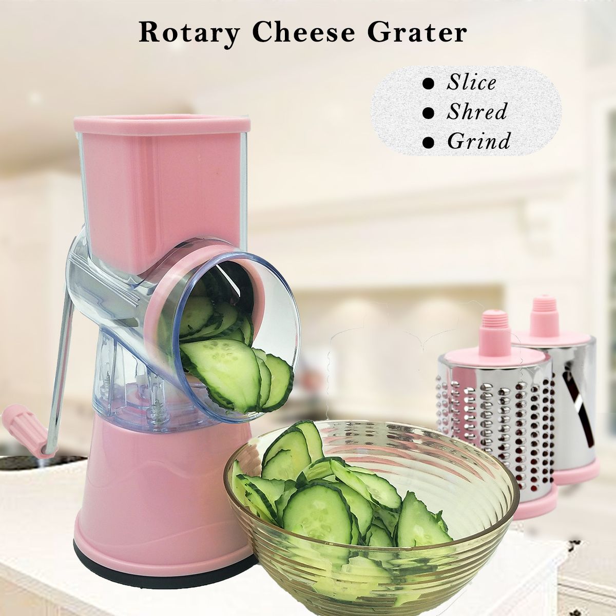 Pink rotary cheese grater with sliced cucumbers and a bowl on a kitchen counter.