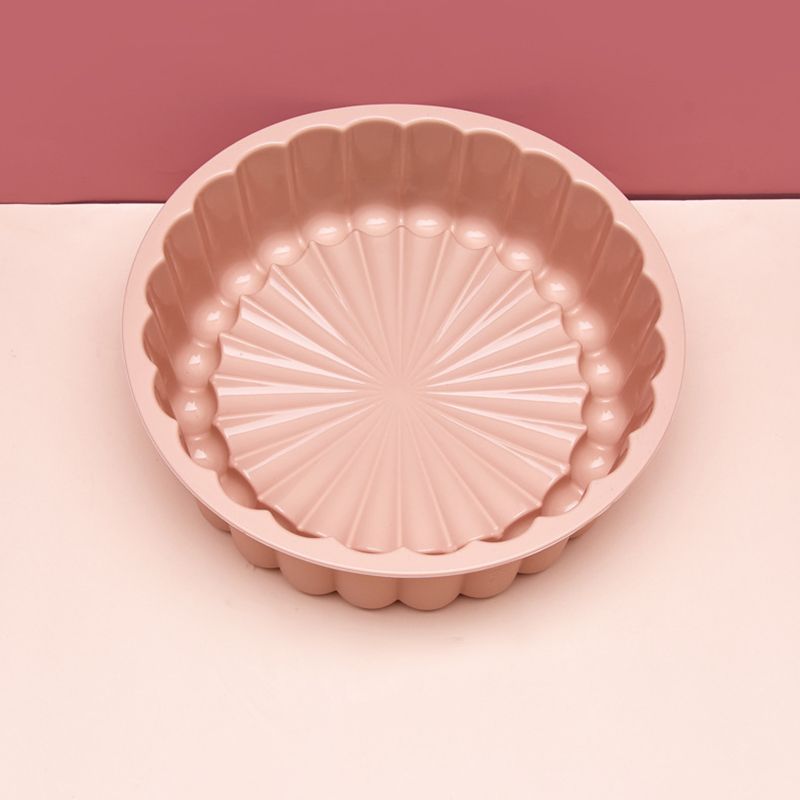 Pink fluted tartlet tin on a pink background