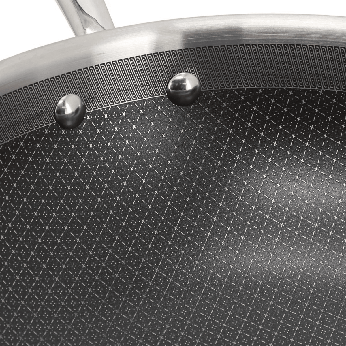 Close-up of a non-stick frying pan with textured surface and metallic handle.