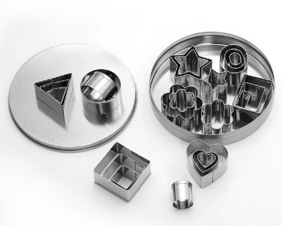 Set of metal cookie cutters with various shapes on a white background
