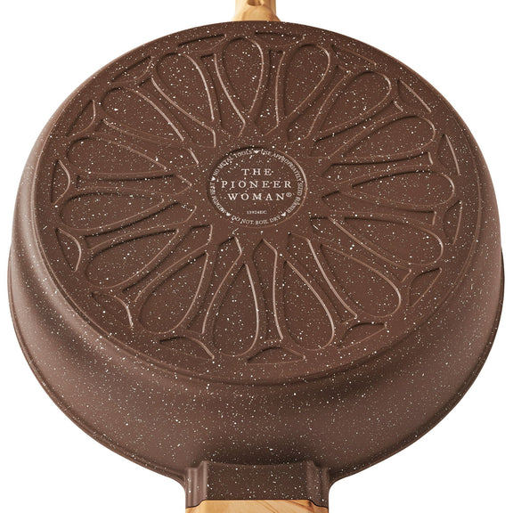 Brown speckled bottom view of frying pan with 'The Pioneer Woman' branding on a white background