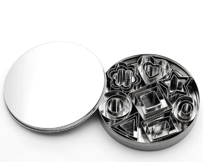 Metallic cookie cutter set with various shapes on a white background