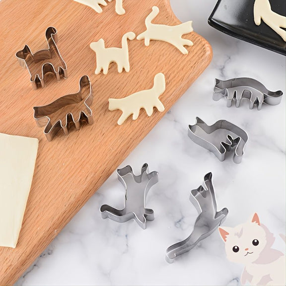 Set of animal-shaped cookie cutters on a marble surface with some cut-out shapes.