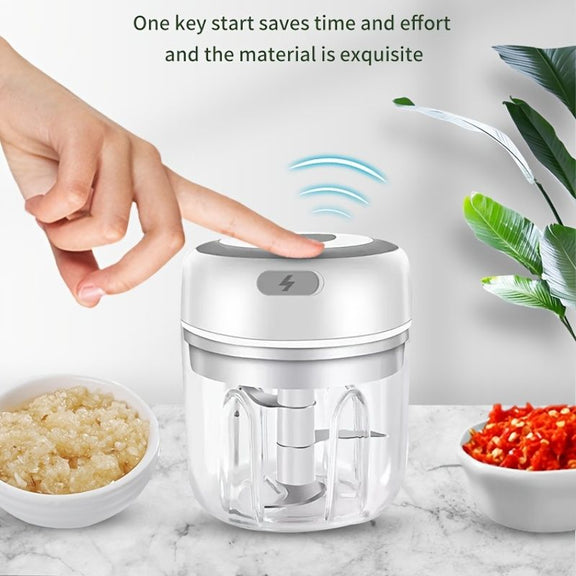 Hand using a small food chopper with text about key start feature and material quality on a marble surface.