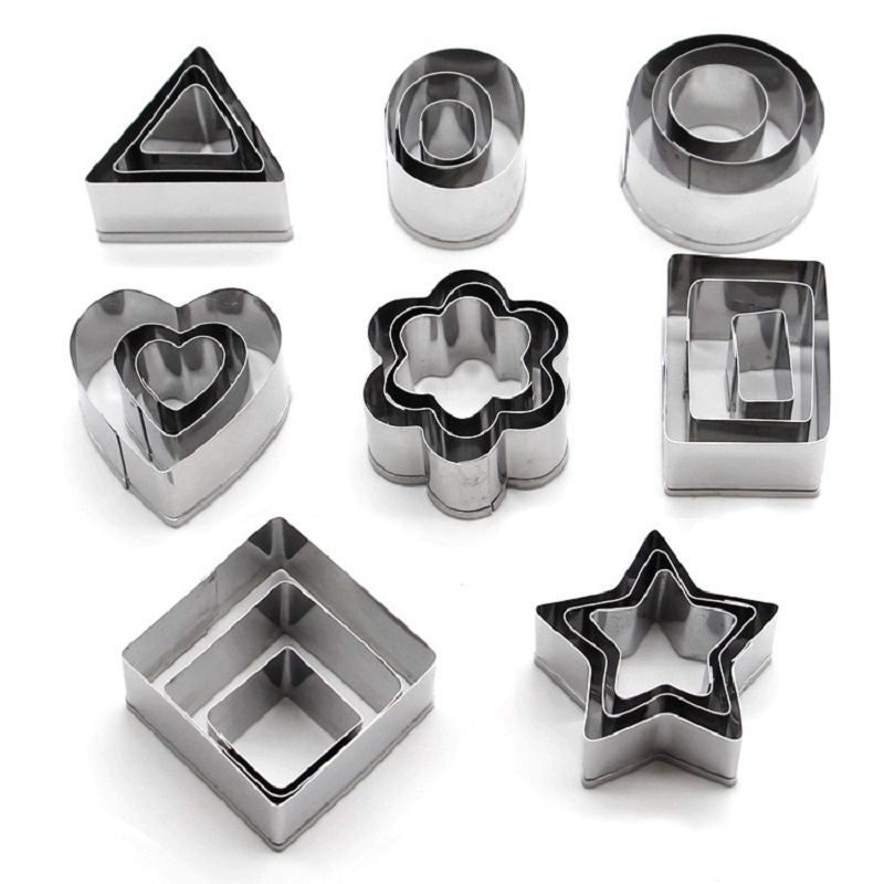 Set of metal cookie cutters in various shapes on a white background
