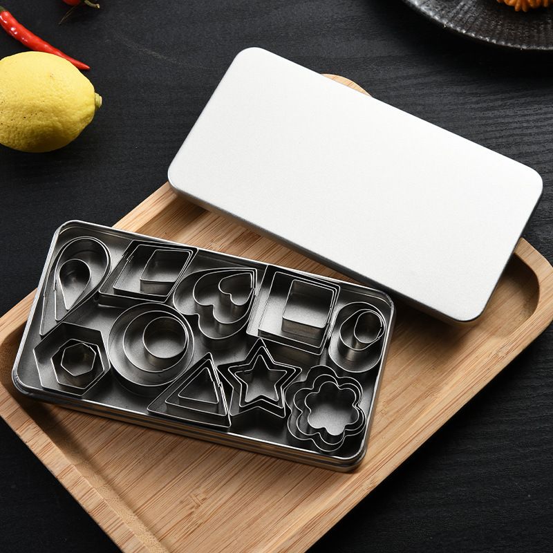 Set of metal cookie cutters on a wooden tray with a white lid.